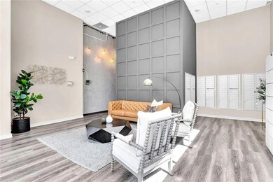 Living area featuring a drop ceiling, baseboards, 