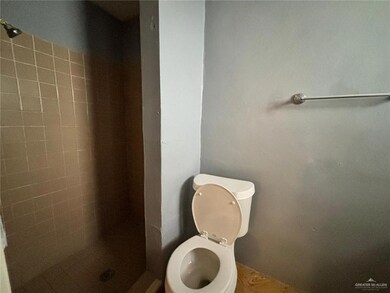 Bathroom with tiled shower and toilet