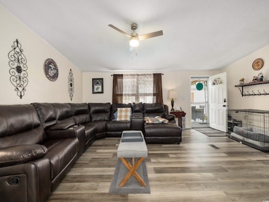 Living room with wood-type flooring, ceiling fan, 
