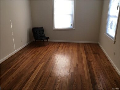 Living room  with refinished hardwood floors.