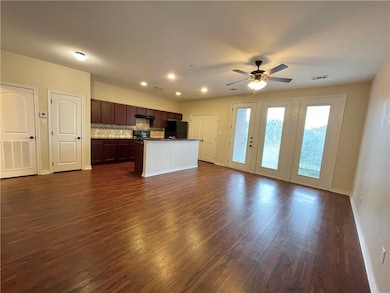 Unfurnished living room featuring dark wood finished floors, recessed lighting, and a ceiling fan