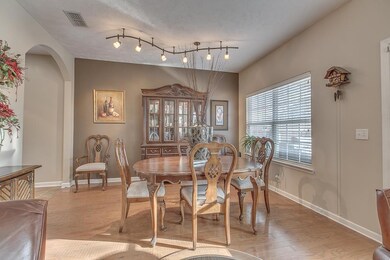 Spacious dining room off great room with room for table and large china cabinet.