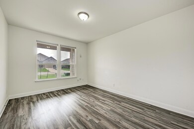 Spare room with dark wood finished floors and bas
