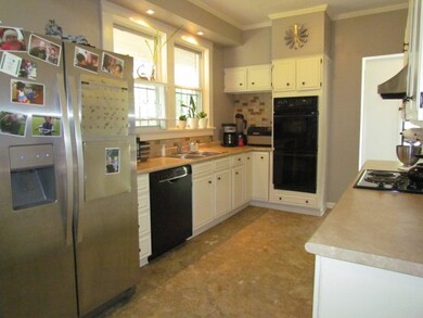 The large kitchen offers ample cabinetry and count