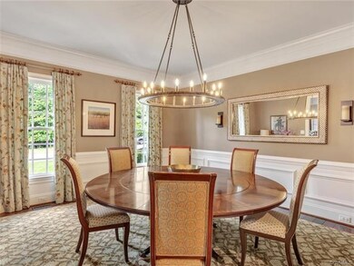 Spacious dining room with beautiful trim, hardwood floors and windows facing the front yard.