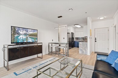 Living area featuring visible vents, light wood-s