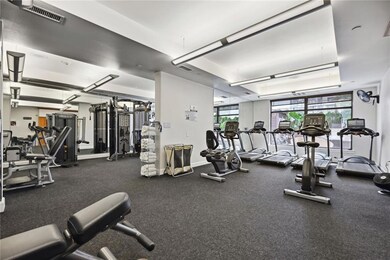 Workout area featuring a raised ceiling