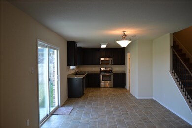 Kitchen featuring sink, a wealth of natural light, hanging light fixtures, and stainless steel appliances