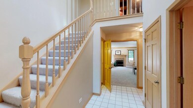 Open staircase with 2 story entry leading to spaci