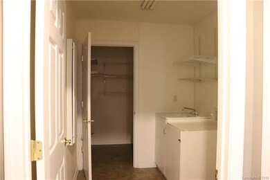 Laundry room with sink and storage room