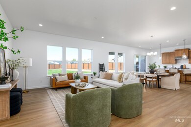Living area featuring a chandelier, light wood-style flooring, and recessed lighting