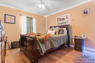 Bedroom featuring baseboards, a textured ceiling, 