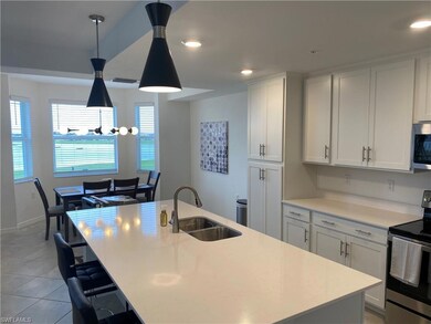 Kitchen with white cabinets, appliances with stain