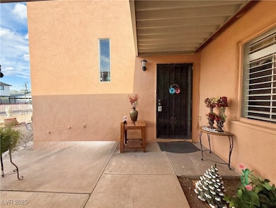 View of exterior entry featuring fence, stucco sid