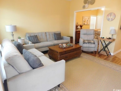 Living room with wood finished floors and baseboards