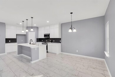Kitchen featuring white cabinets, appliances with 