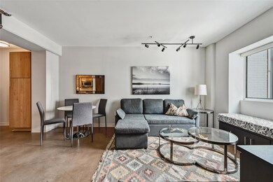 Living room featuring baseboards, track lighting,