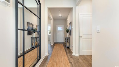 Hall featuring wood finished floors, baseboards, and recessed lighting