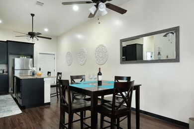 Dining area with dark wood-style floors, a ceiling fan, and recessed lighting