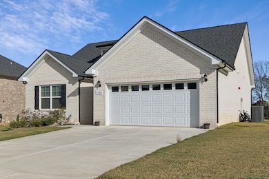 Front of home with parking and 2 car attached garage.