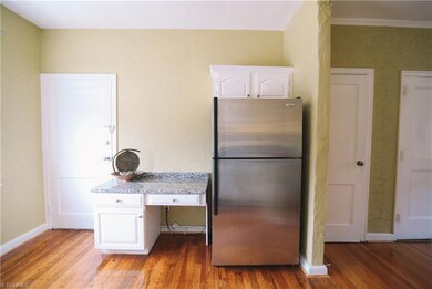Built-in desk keeps you organized!  This door leads to the basement and the Main Street entrance. Refrigerator remains.