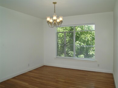Spare room featuring wood finished floors, basebo