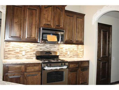 Kitchen. Stainless appliances, maple wood, granite