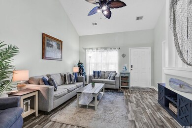 Living room with ceiling fan, dark hardwood / wood