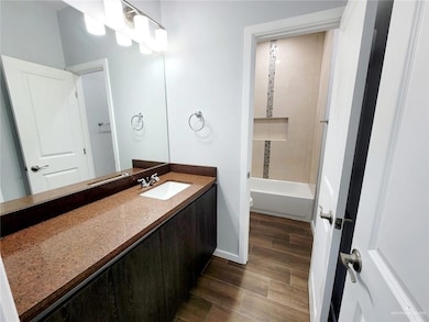 Full bath with wood finished floors, vanity, toilet, and baseboards