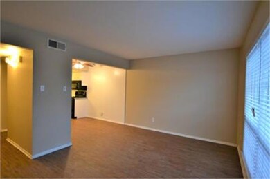 Spare room featuring ceiling fan and dark colored 