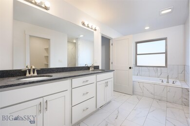 Fully tiled master bathroom with walk in closet.