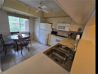 Kitchen featuring a sink, light tile patterned flo