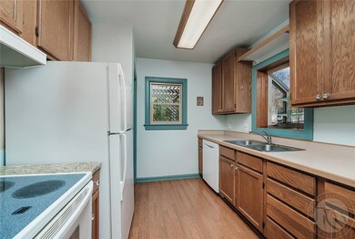 Kitchen with smooth top range, dishwasher, refrige