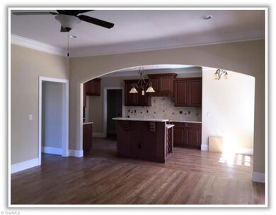Oversized kitchen with breakfast area overlooking sunroom and living room.