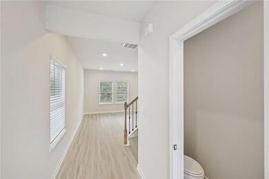 Hall with visible vents, light wood-type flooring,