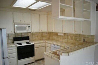 The light and bright tiled Kitchen has newer appli