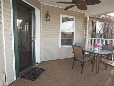 The covered front porch with ceiling fan welcomes 