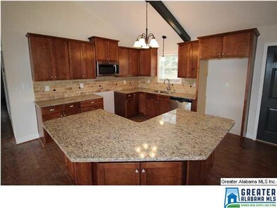 Kitchen has maple cabinets, pretty backsplash, and