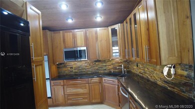 Large updated kitchen with black granite countertops