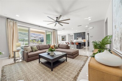 Living area featuring a ceiling fan, light tile pa