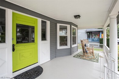 Entrance to property featuring a porch and original wood front door with sidelights