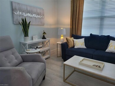 Living area with wood finished floors and baseboards
