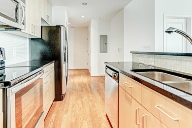 The kitchen has mosaic tile backsplash, undermount