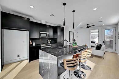 Kitchen with dark cabinets, appliances with stain