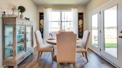 Dining area with dark hardwood / wood-style flooring and french doors