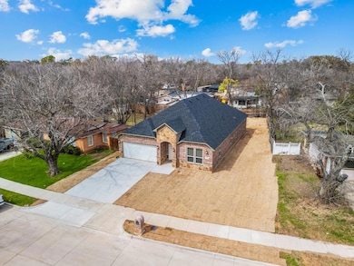 View of front of property featuring a garage, fenc