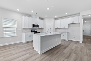 Kitchen featuring white cabinetry, a kitchen islan