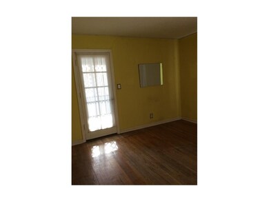Living room offers original hardwood floors.