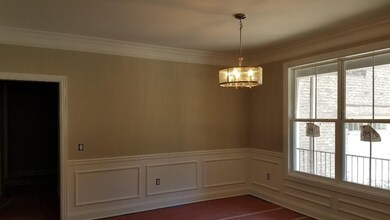 Elegant dining room with wainscot.  Sand and finish hardwood underneath the protective paper!