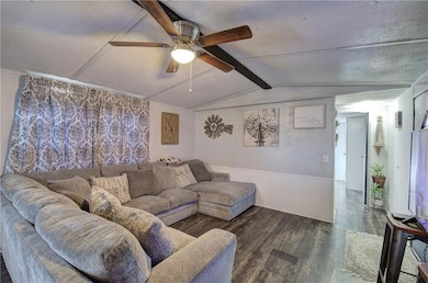 Living room featuring vaulted ceiling with beams, 